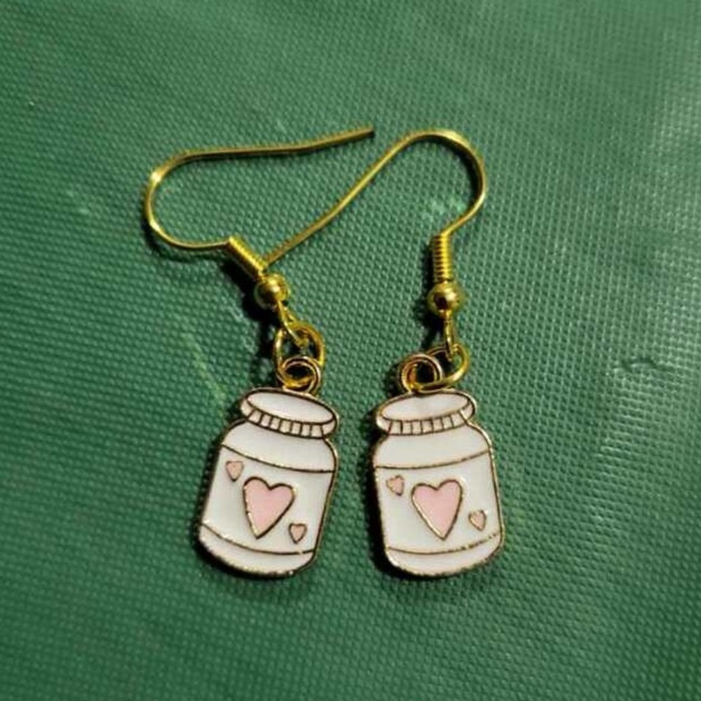 White jar with pink heart earrings